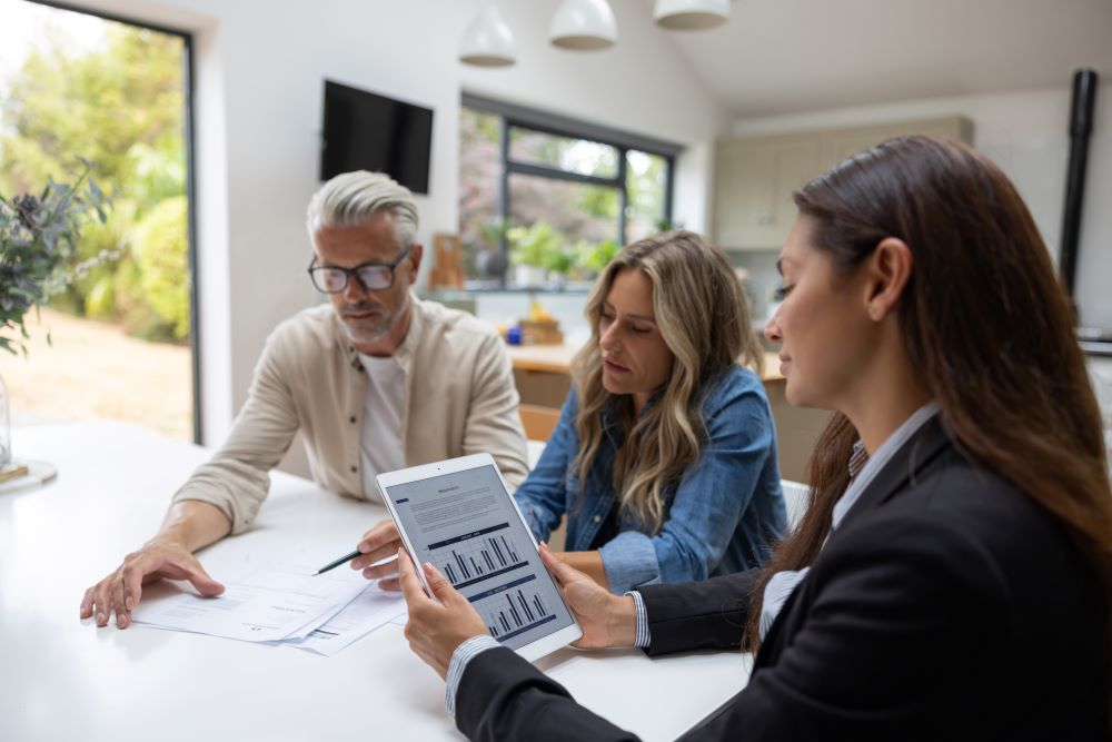 Three persons talking about home worth